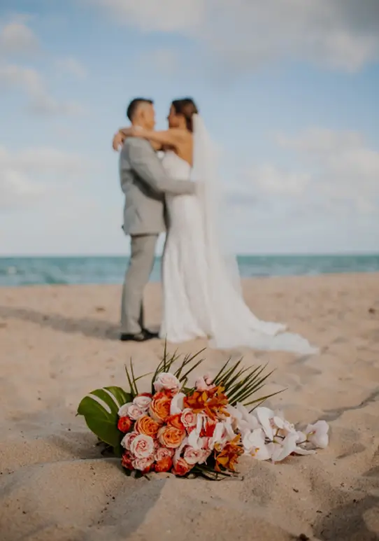Bride and groom embracing on the beach at Sea Watch on the Ocean