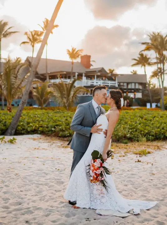 Bride and groom embracing during a beachfront wedding at Sea Watch on the Ocean